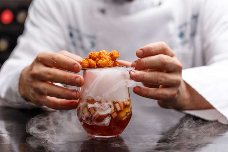 Spectacular cocktail with dry ice fog and fresh fruits